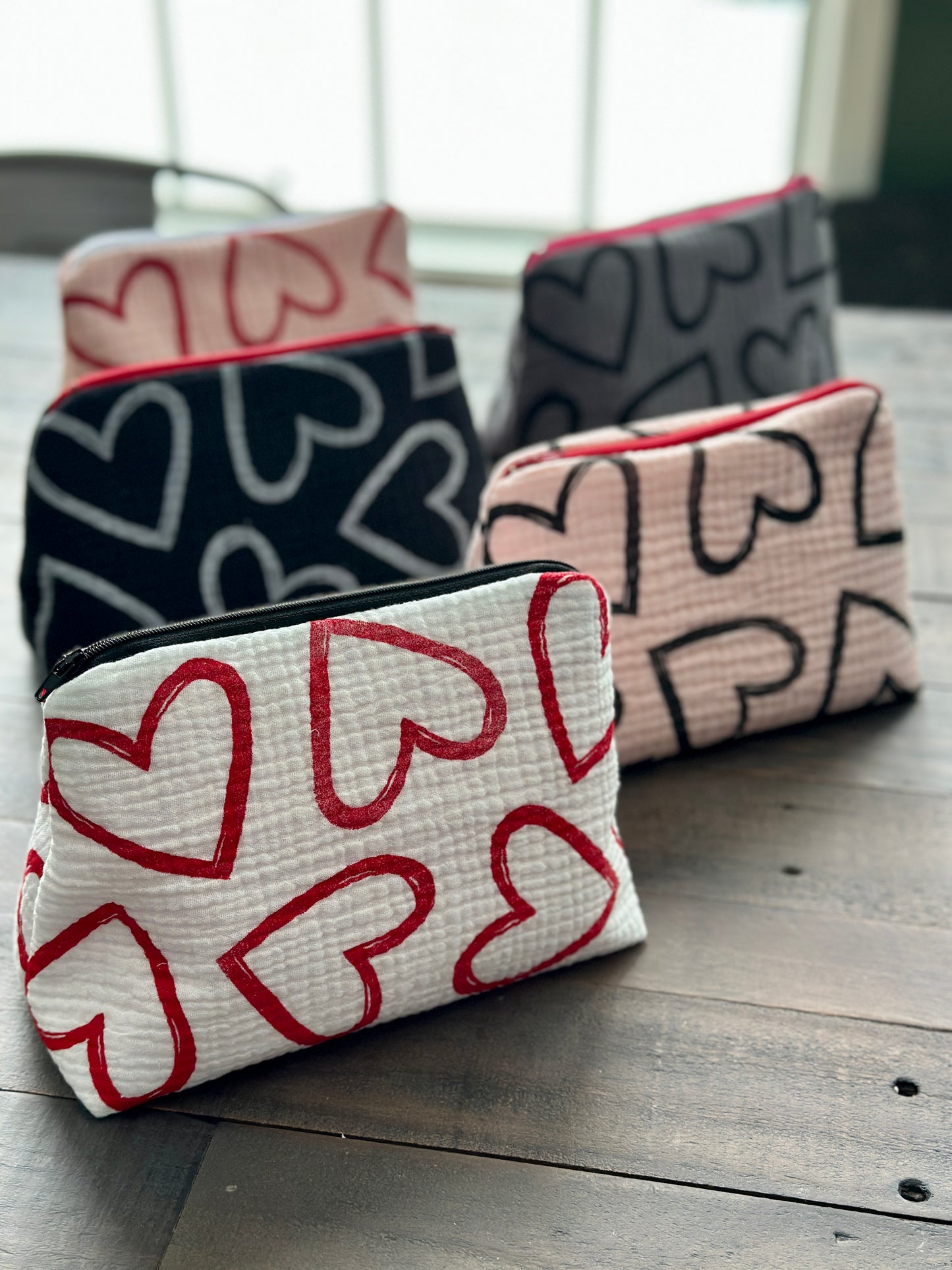 pink zipper pouch with black hearts pattern