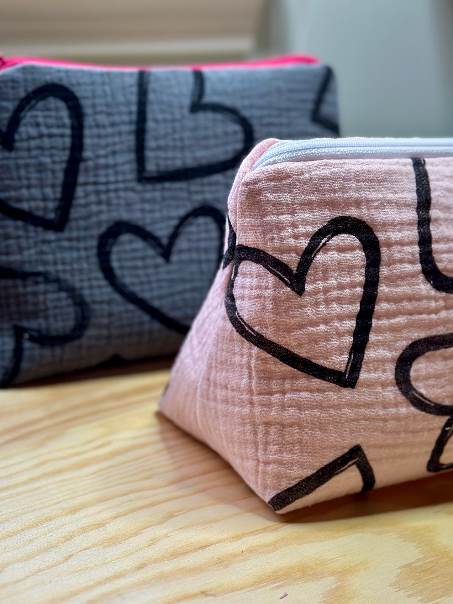 pink zipper pouch with black hearts pattern