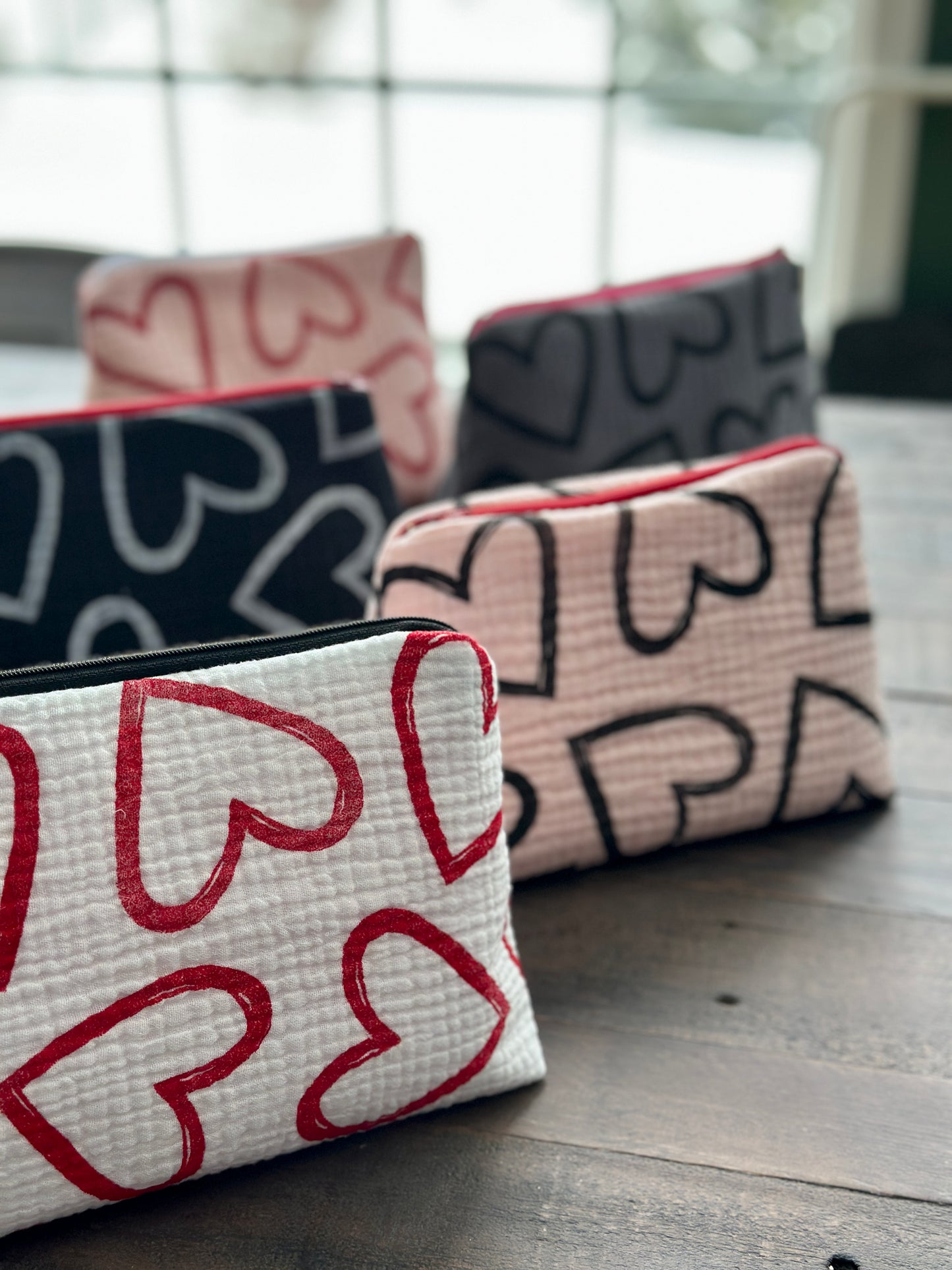 pink zipper pouch with black hearts pattern