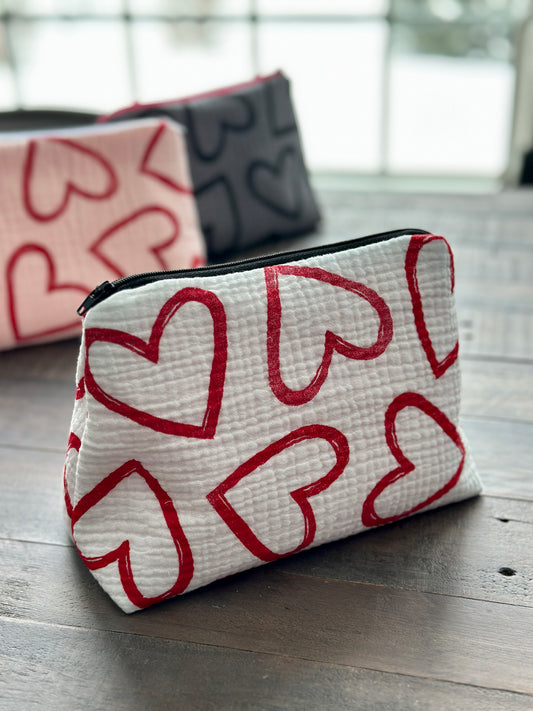 white zipper pouch with red hearts pattern