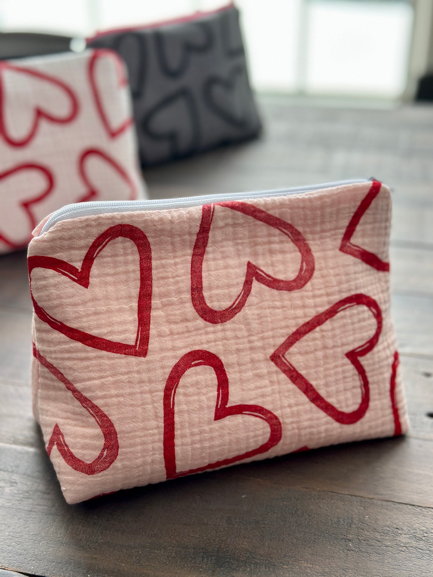pink zipper pouch with red hearts pattern
