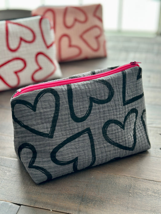 gray zipper pouch with black hearts pattern