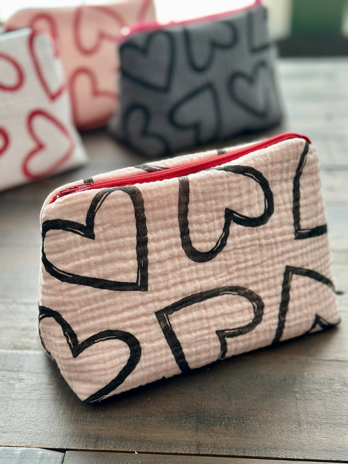 pink zipper pouch with black hearts pattern
